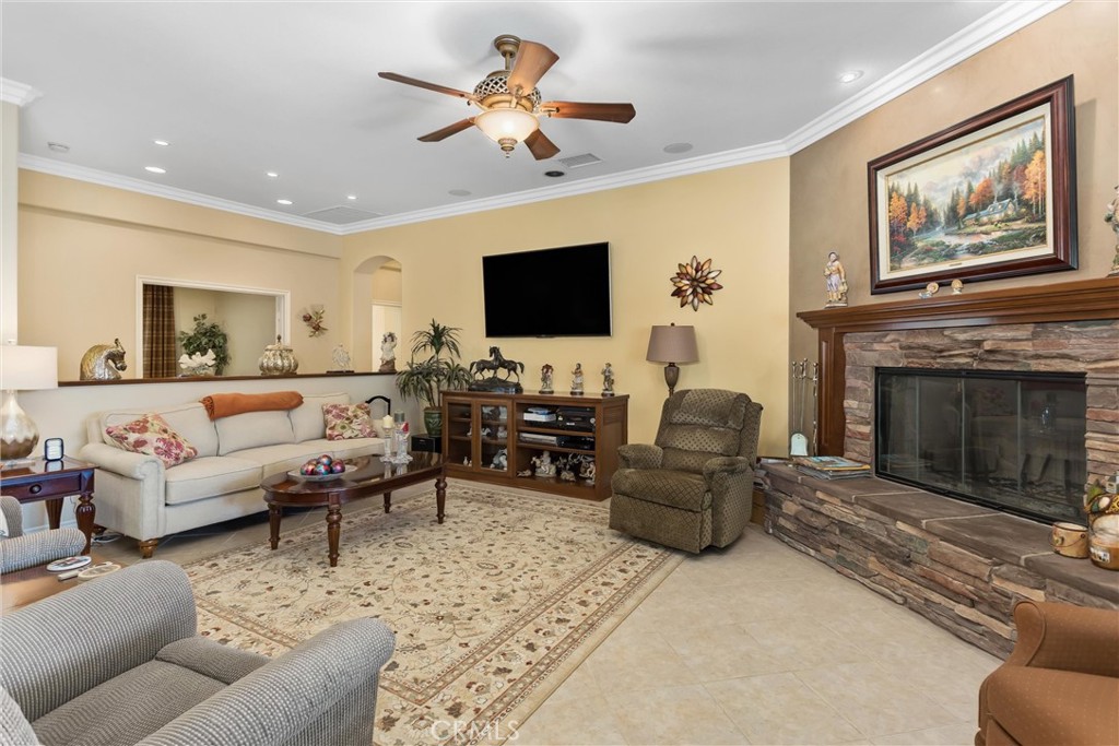 9841 Kehl Canyon Road Beaumont, CA 92223 - Photo 21 of 57 a living room with furniture a fireplace and a flat screen tv