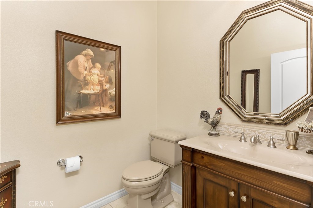 9841 Kehl Canyon Road Beaumont, CA 92223 - Photo 25 of 57 a bathroom with a toilet a sink and mirror