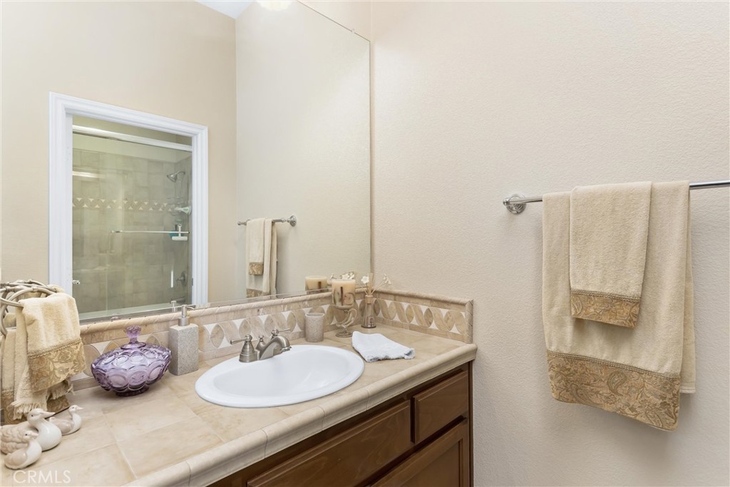 9841 Kehl Canyon Road Beaumont, CA 92223 - Photo 28 of 57 a bathroom with a granite countertop sink and a mirror