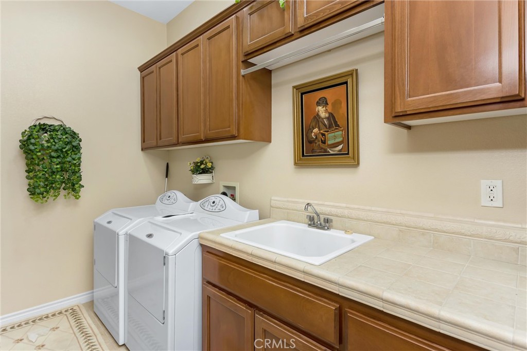9841 Kehl Canyon Road Beaumont, CA 92223 - Photo 32 of 57 a utility room with a sink a washer and dryer