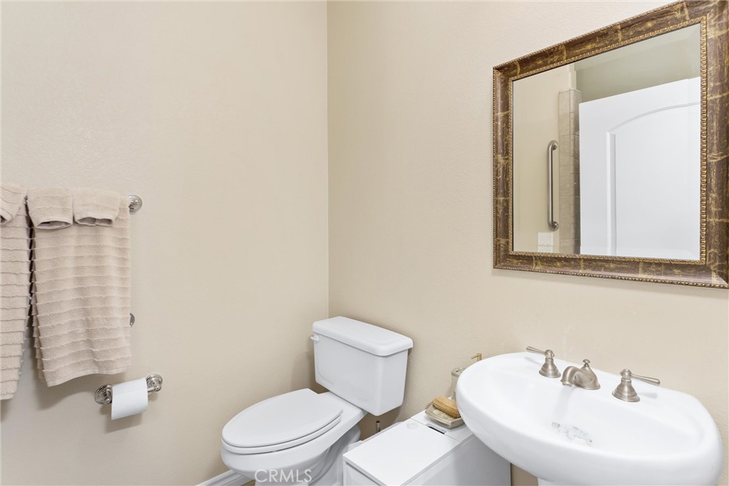 9841 Kehl Canyon Road Beaumont, CA 92223 - Photo 34 of 57 a bathroom with a sink a mirror and a toilet
