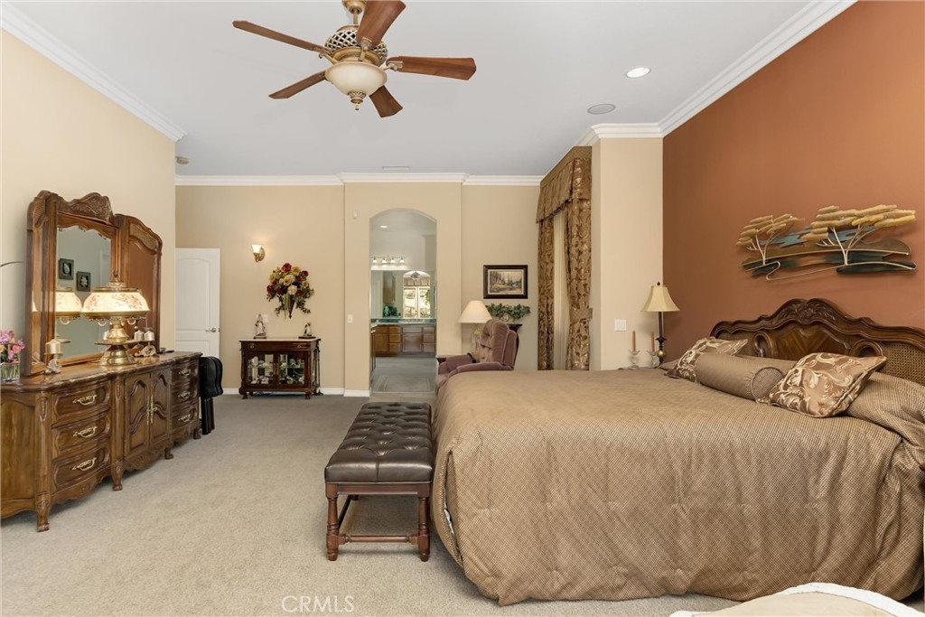 9841 Kehl Canyon Road Beaumont, CA 92223 - Photo 37 of 57 a bedroom with a bed couch and a flat tv screen