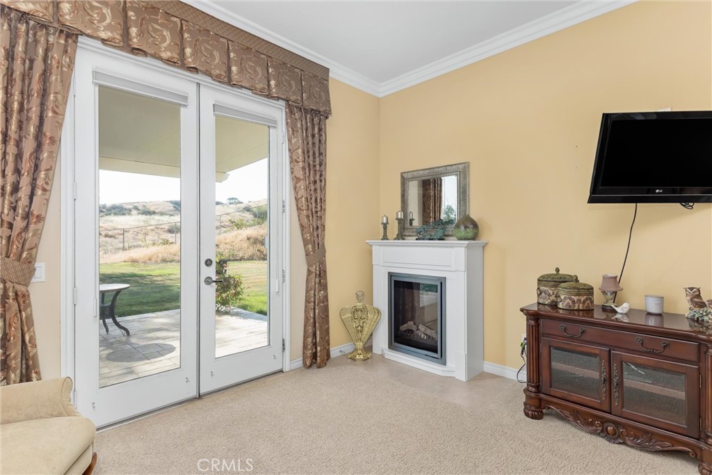 9841 Kehl Canyon Road Beaumont, CA 92223 - Photo 38 of 57 a living room with furniture a flat screen tv and floor to ceiling window