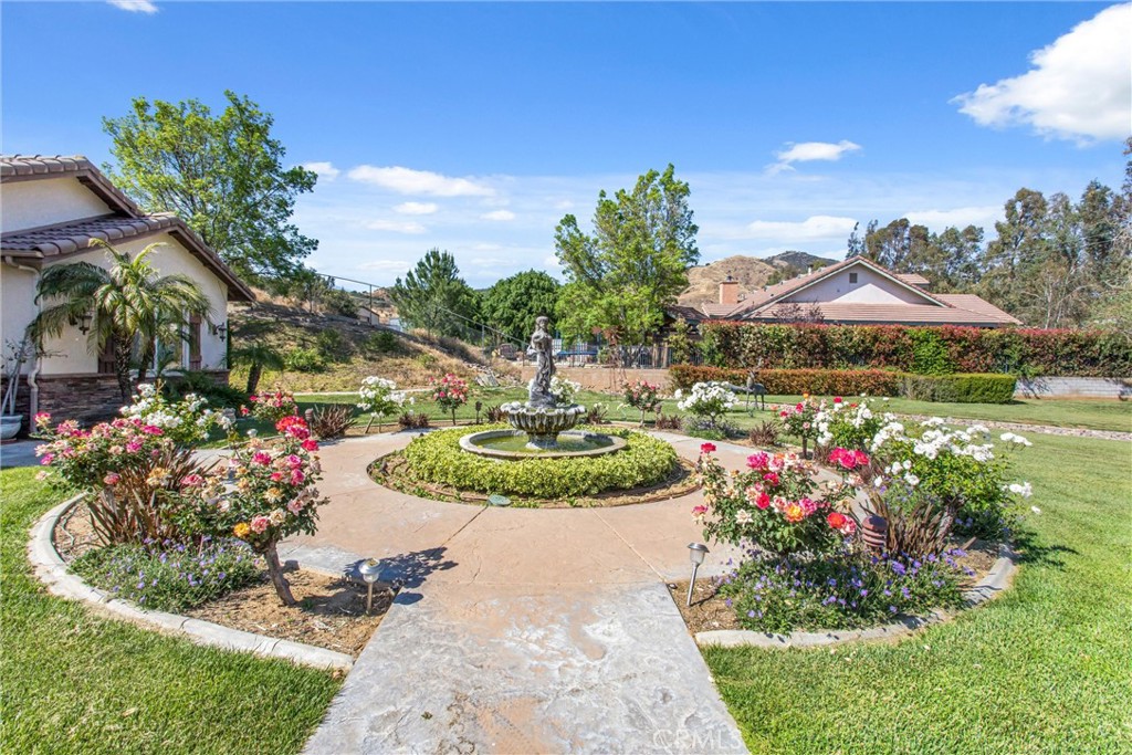 9841 Kehl Canyon Road Beaumont, CA 92223 - Photo 8 of 57 a view of a swimming pool in he middle of the green field