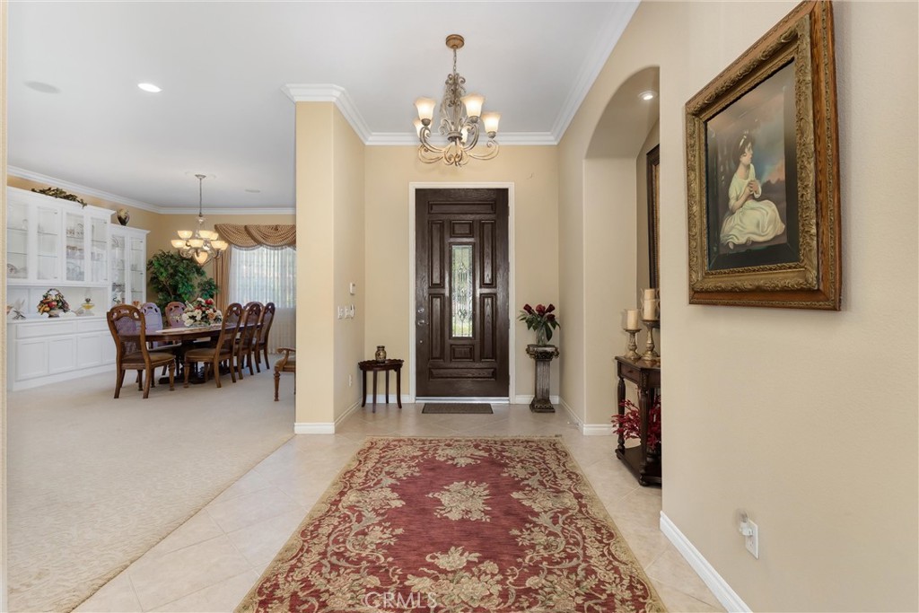 9841 Kehl Canyon Road Beaumont, CA 92223 - Photo 10 of 57 a living room with furniture and a chandelier
