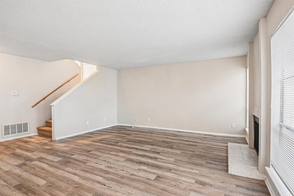 5534 Boca Raton Boulevard, Unit 292 Fort Worth, TX 76112 - Photo 8 of 31 a view of an empty room with wooden floor and a window