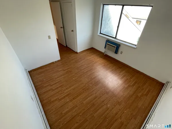 an empty room with wooden floor