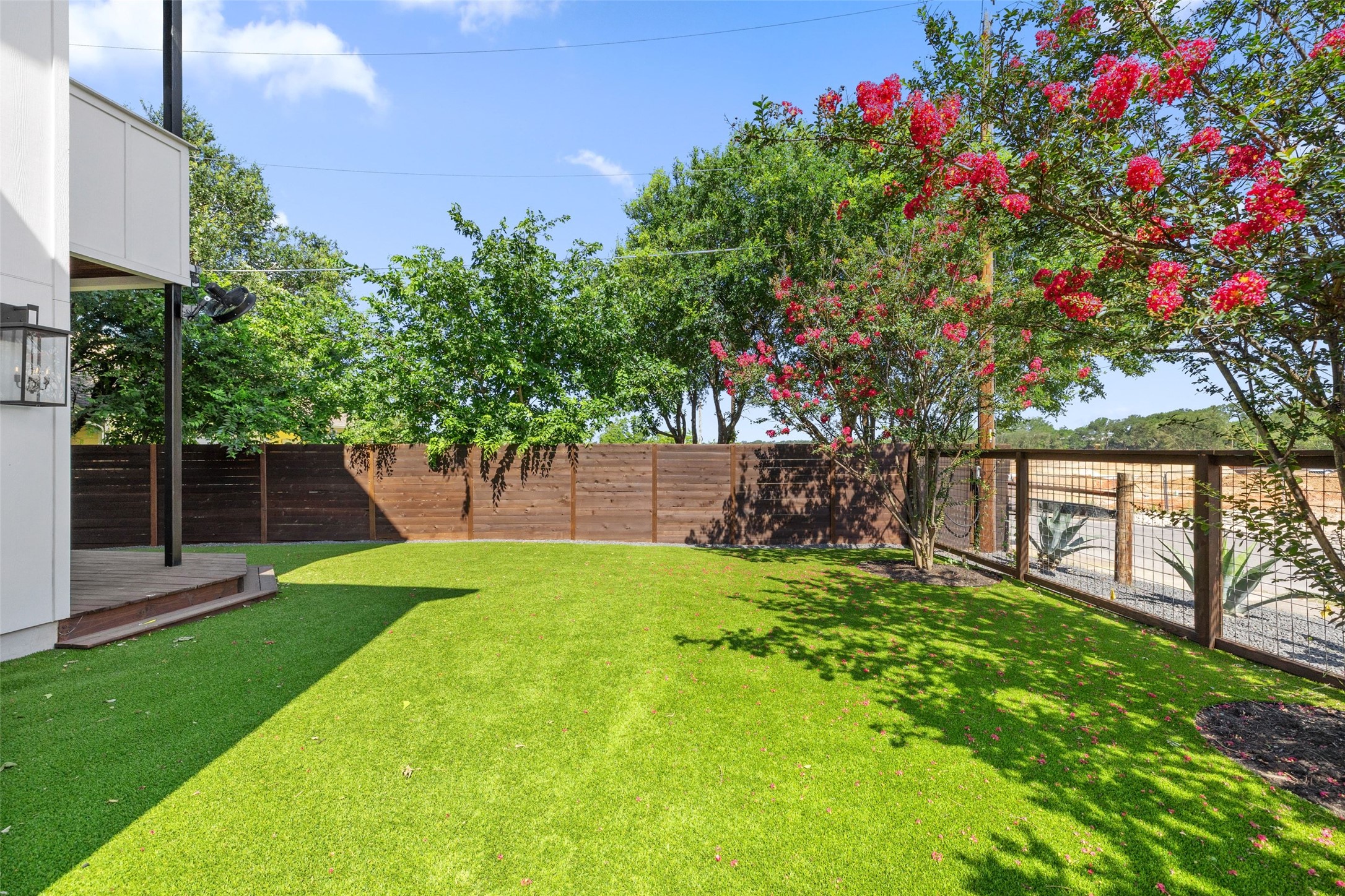 5601 Jackie Robinson Street, Unit 1 Austin, TX 78721 - Photo 35 of 40 Mature landscaping surrounds the property, while an original hitching post offers a rare nod to East Austin’s historic roots.