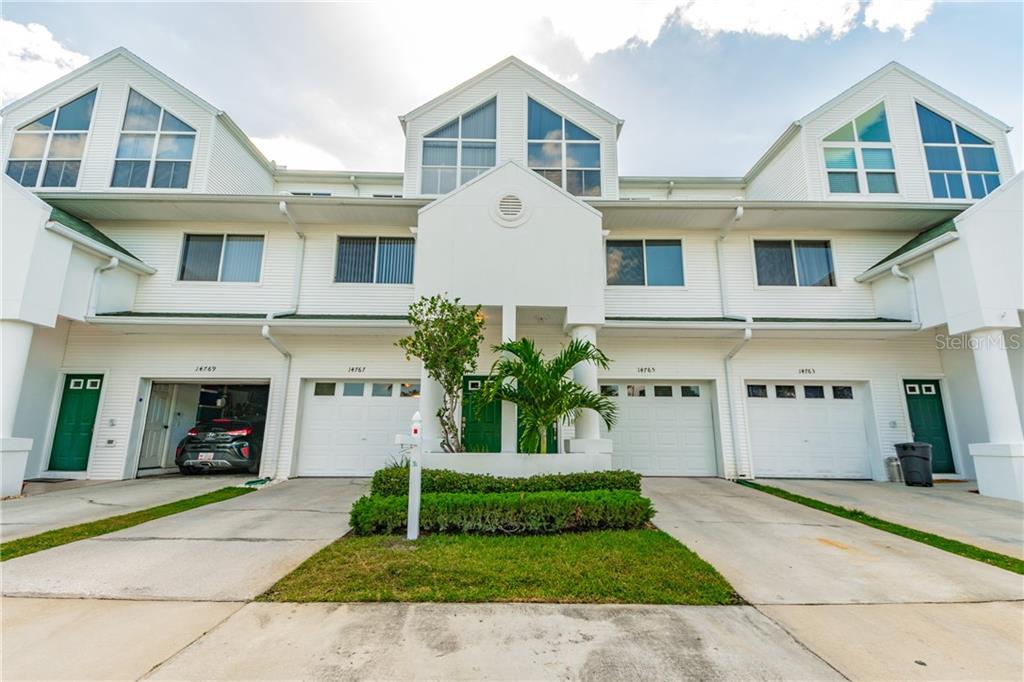 14767 Seminole Trail Seminole, FL 33776 - Photo 1 of 1 a front view of a house with a yard and potted plants