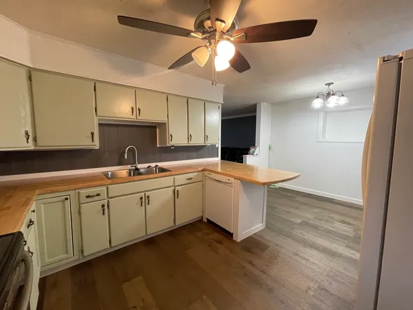 a kitchen with a sink cabinets and window