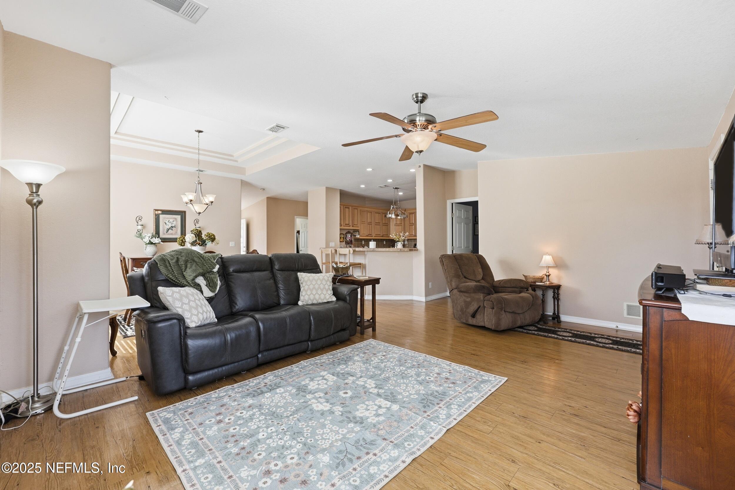 112 Waterside Avenue Satsuma, FL 32189 - Photo 12 of 52 a living room with furniture wooden floor and a rug