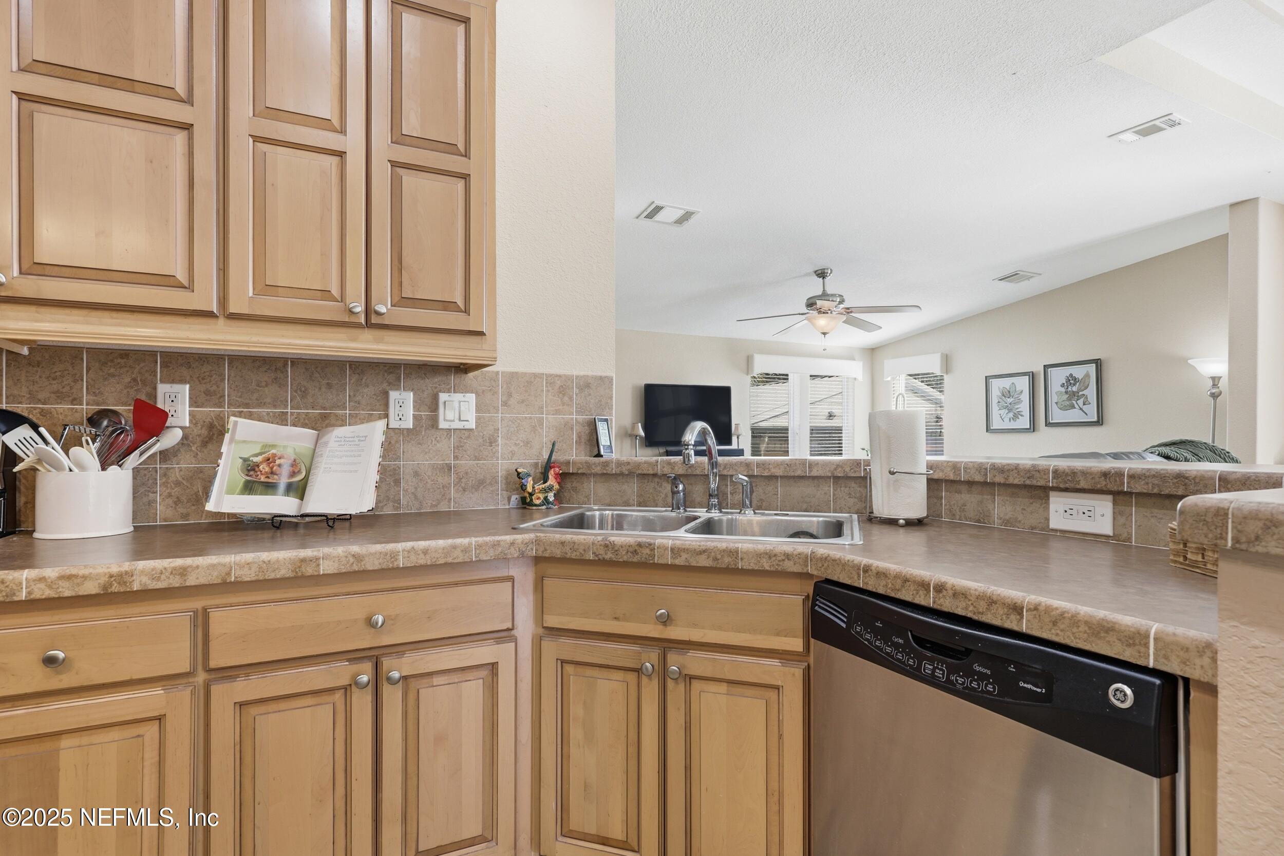 112 Waterside Avenue Satsuma, FL 32189 - Photo 17 of 52 a kitchen with granite countertop stainless steel appliances sink and cabinets