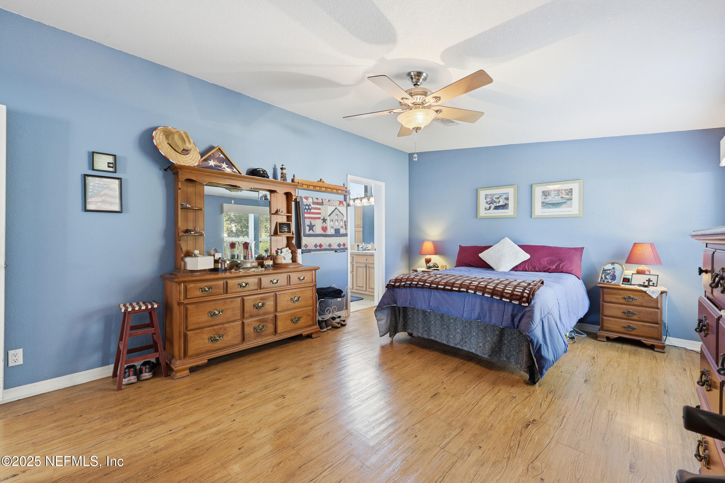 112 Waterside Avenue Satsuma, FL 32189 - Photo 21 of 52 a bed room with a bed and a chandelier