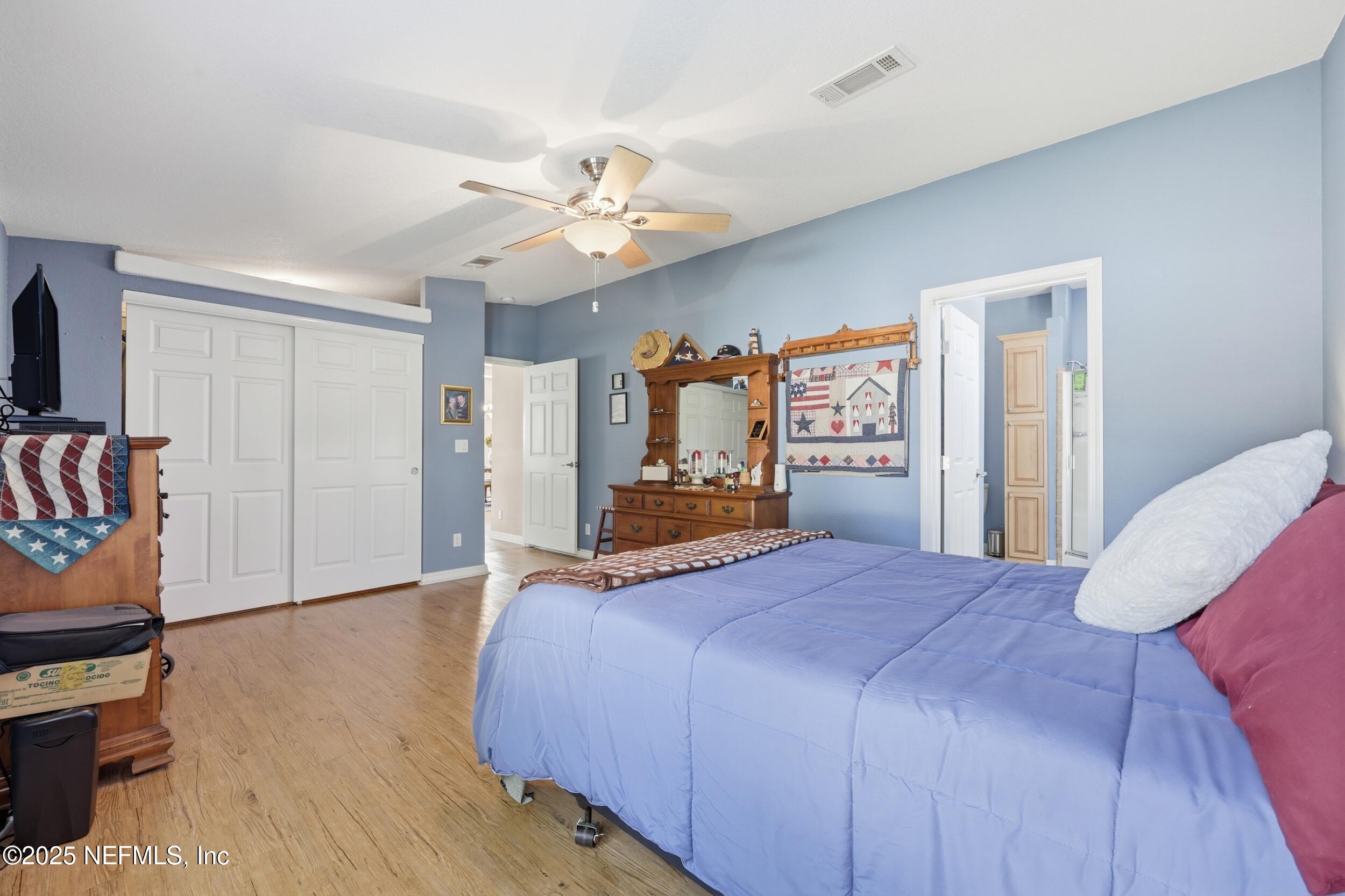 112 Waterside Avenue Satsuma, FL 32189 - Photo 22 of 52 a bedroom with a large bed wooden floor and window