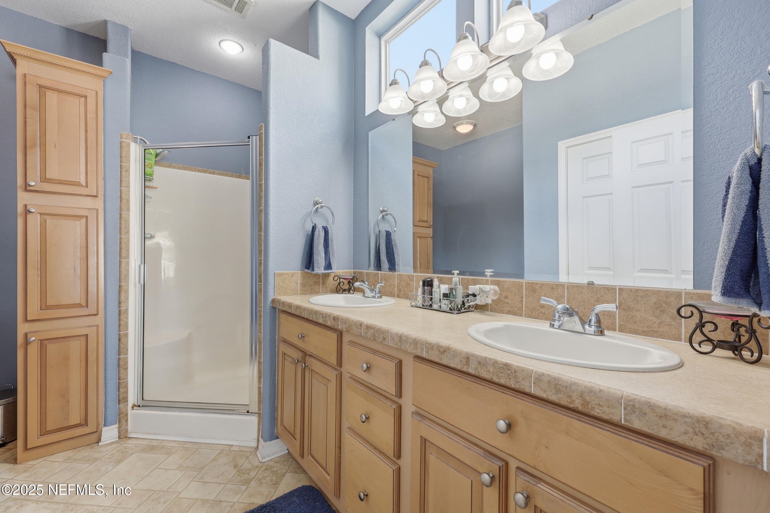 112 Waterside Avenue Satsuma, FL 32189 - Photo 23 of 52 a bathroom with a granite countertop sink a mirror and a shower
