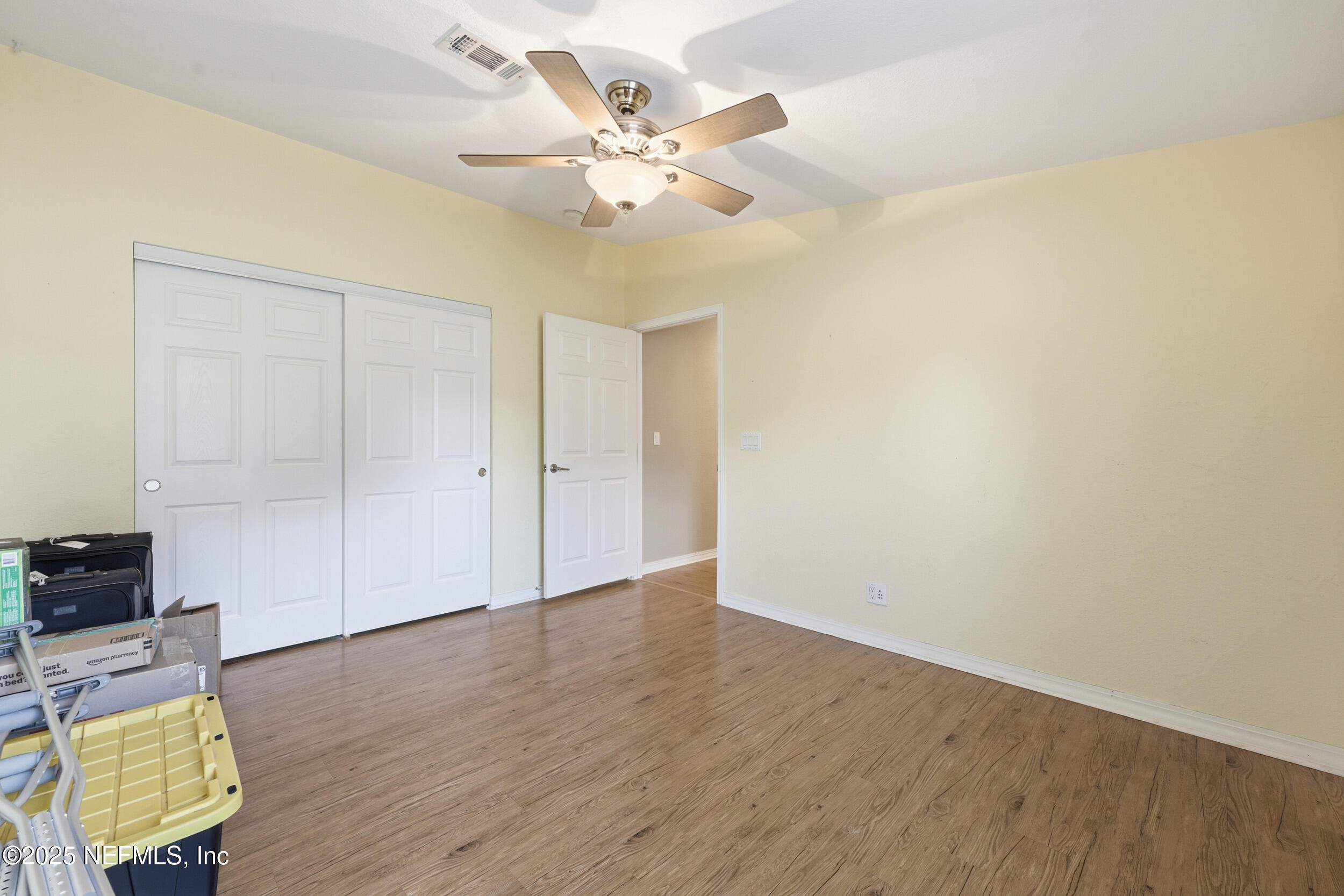 112 Waterside Avenue Satsuma, FL 32189 - Photo 25 of 52 an empty room with wooden floor and fan