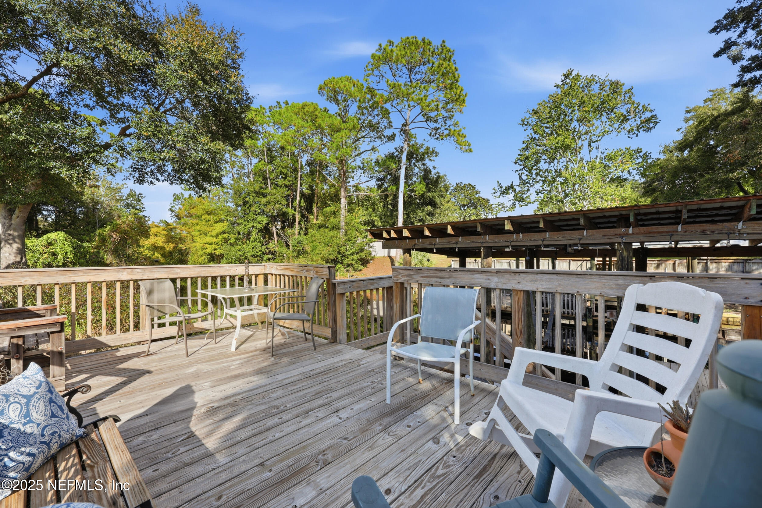 112 Waterside Avenue Satsuma, FL 32189 - Photo 32 of 52 a view of a chairs and table on the wooden deck