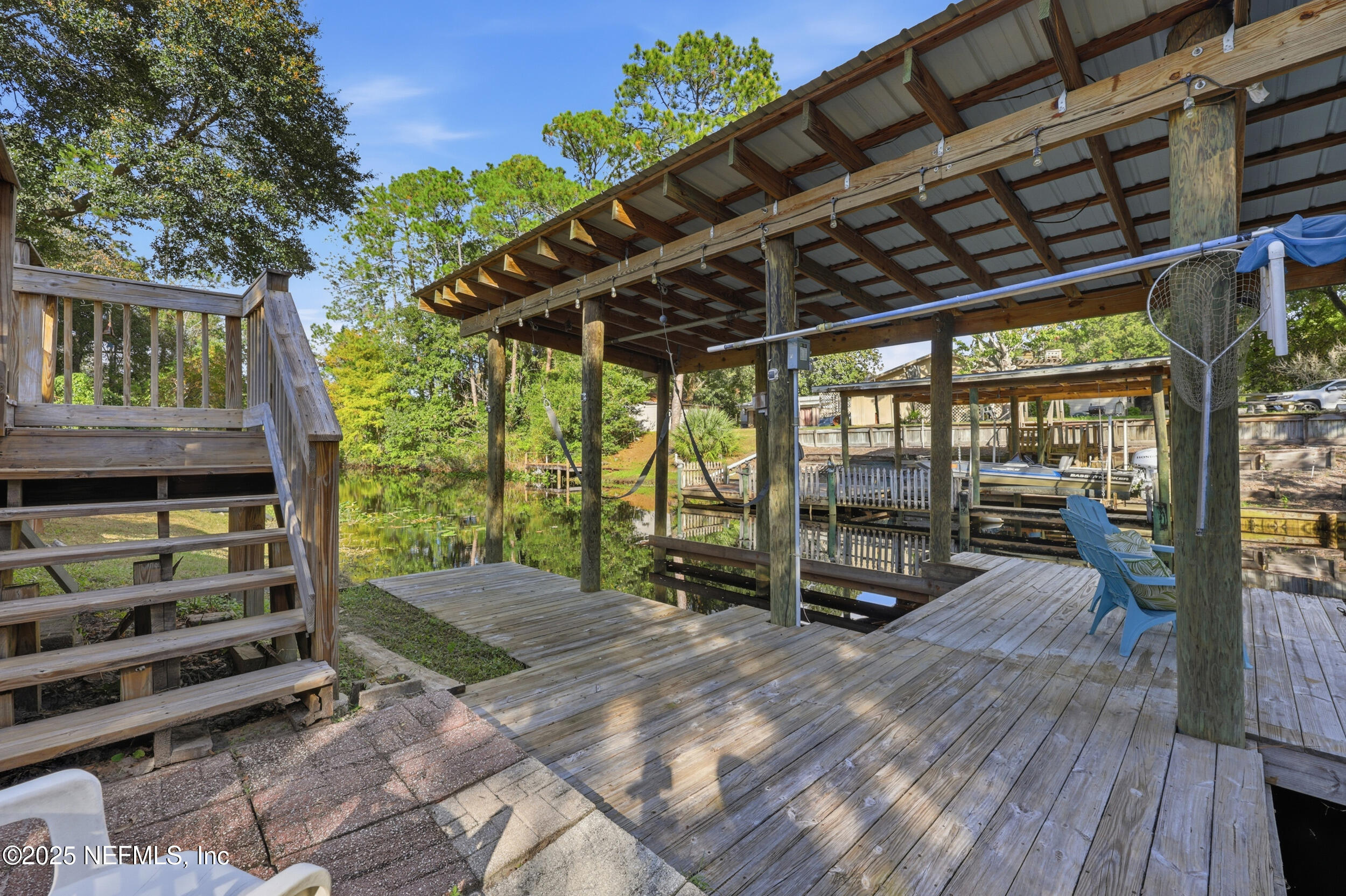 112 Waterside Avenue Satsuma, FL 32189 - Photo 33 of 52 a backyard of a house with barbeque oven table and chairs