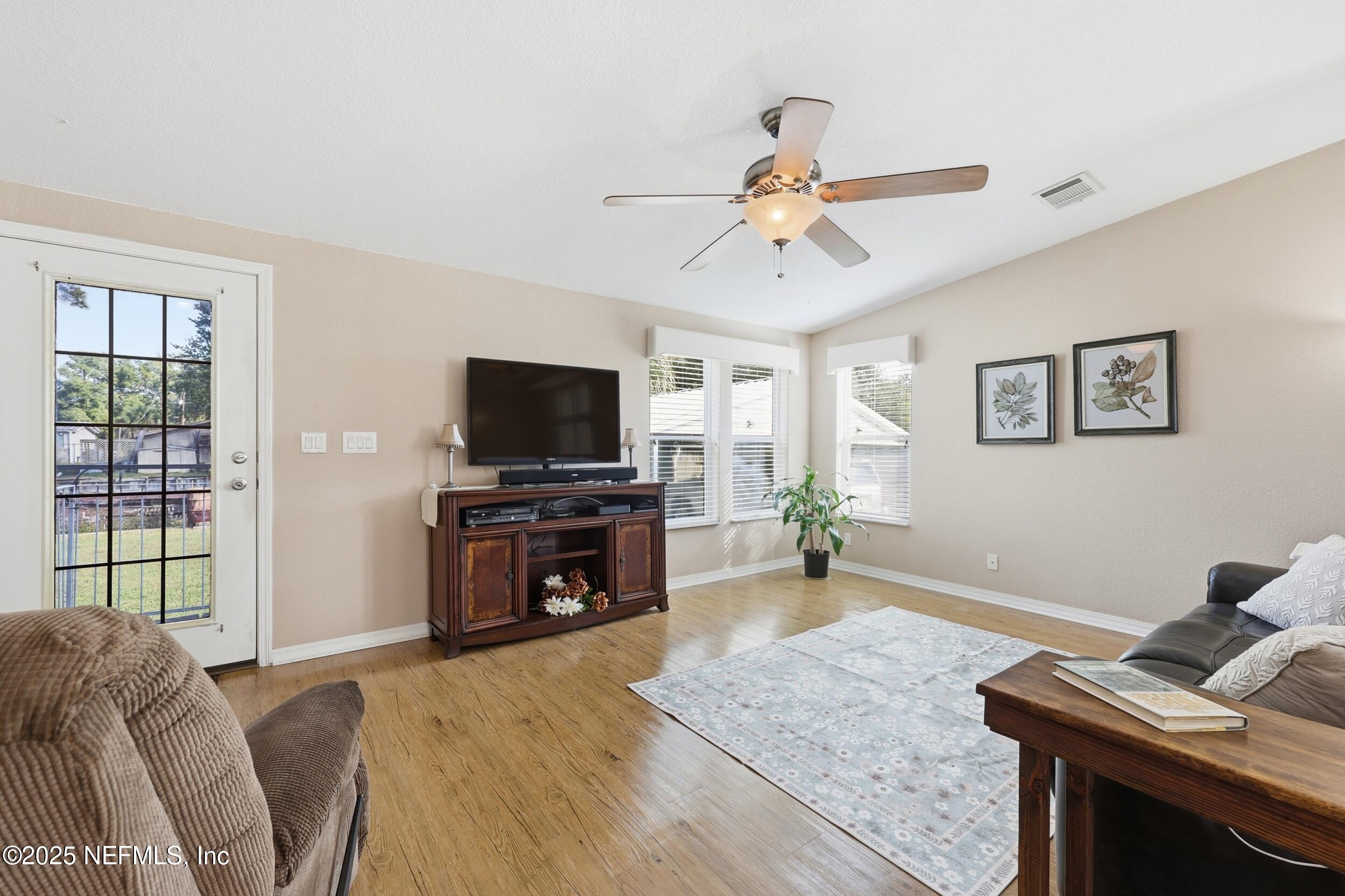112 Waterside Avenue Satsuma, FL 32189 - Photo 9 of 52 a living room with furniture and a flat screen tv