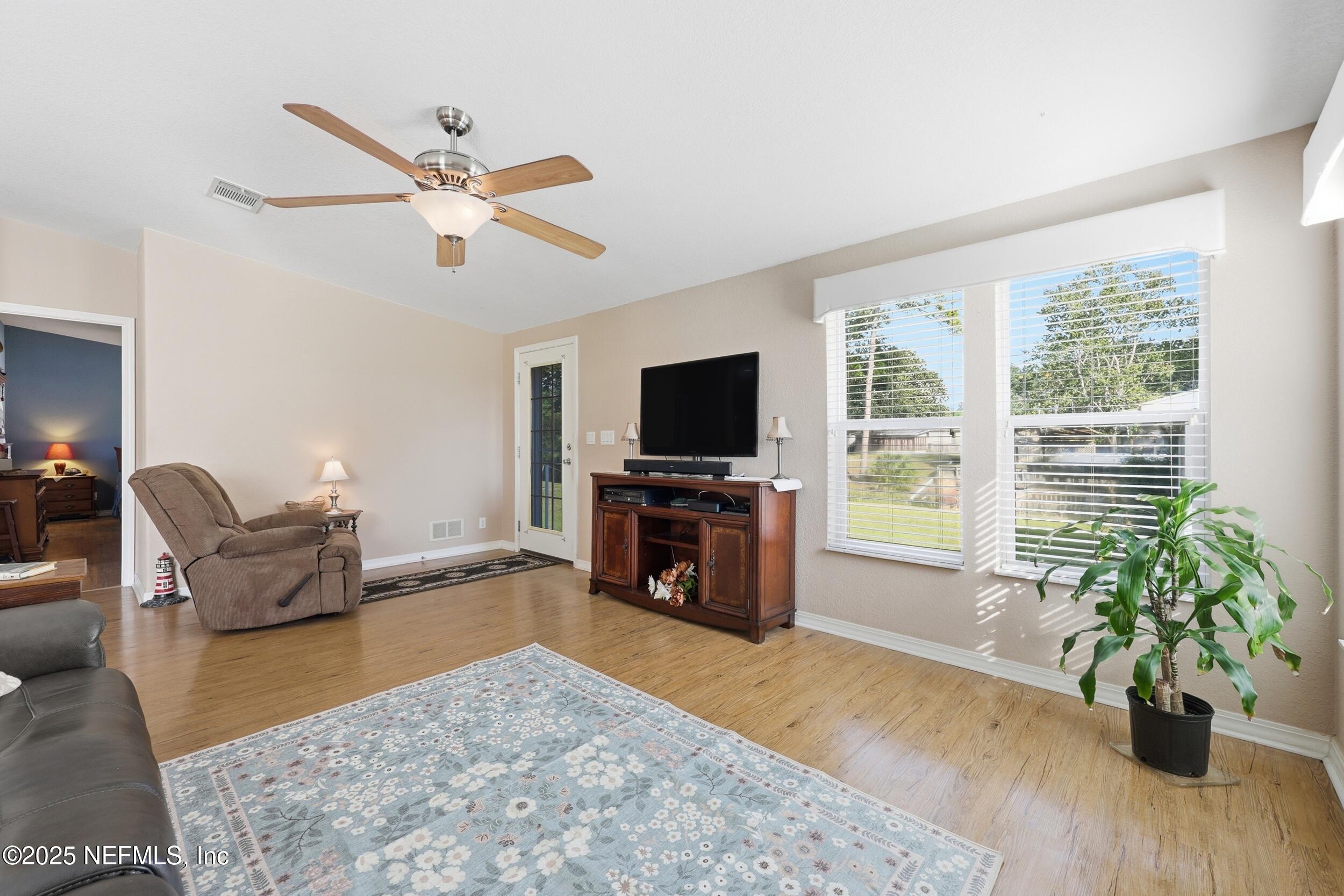 112 Waterside Avenue Satsuma, FL 32189 - Photo 10 of 52 a living room with furniture and a flat screen tv