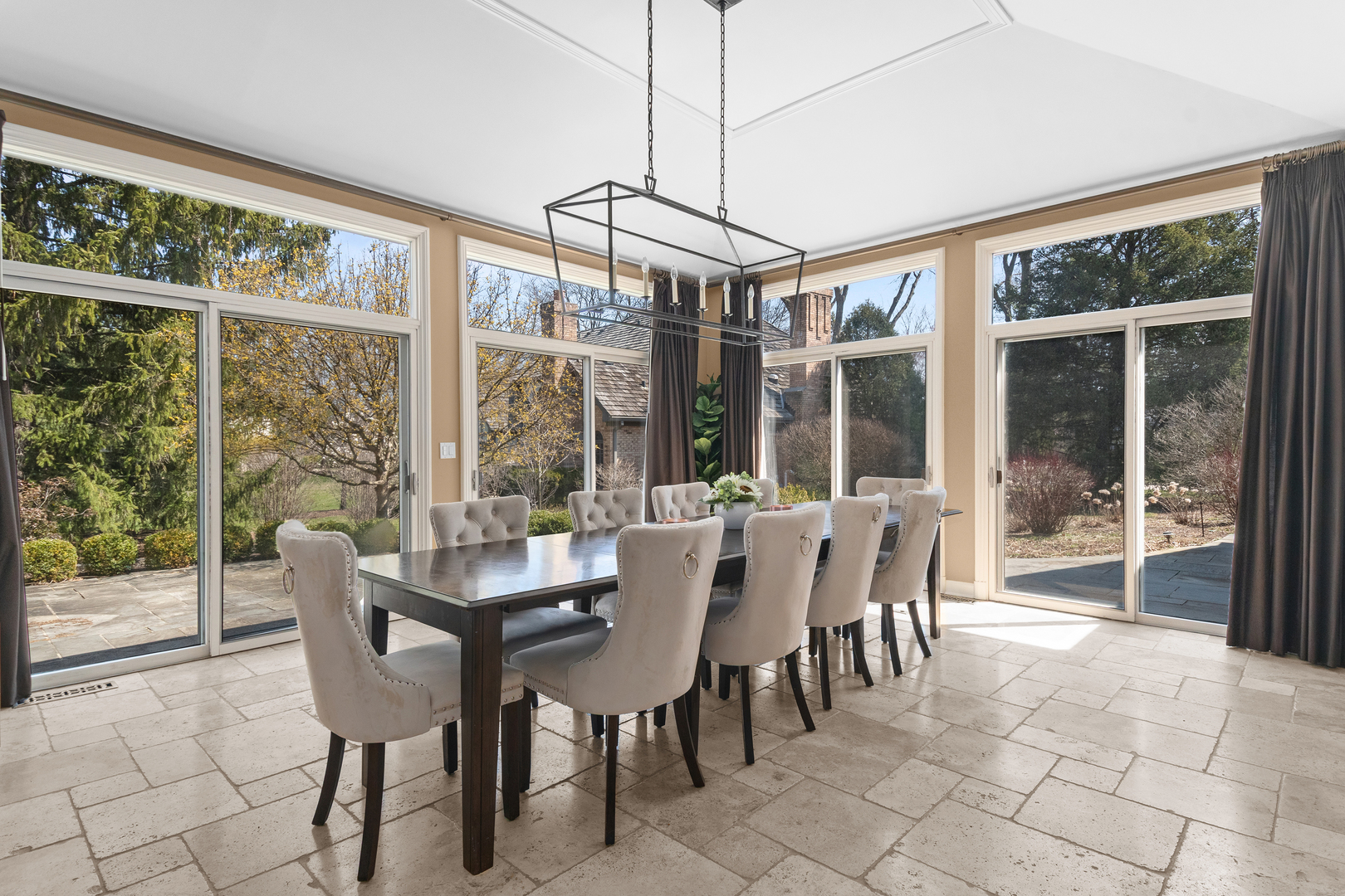 720 Newcastle Drive Lake Forest, IL 60045 - Photo 12 of 42 a view of a dining room with furniture large windows and outside view
