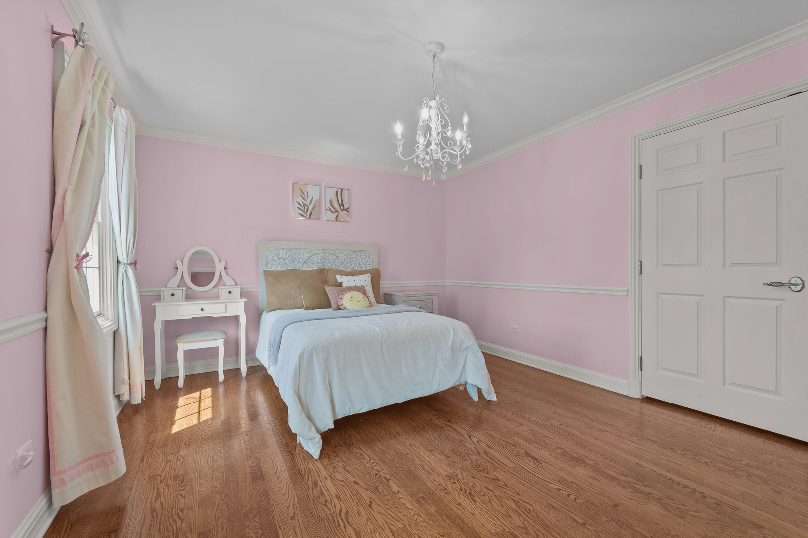 720 Newcastle Drive Lake Forest, IL 60045 - Photo 26 of 42 a bedroom with a bed and a chandelier