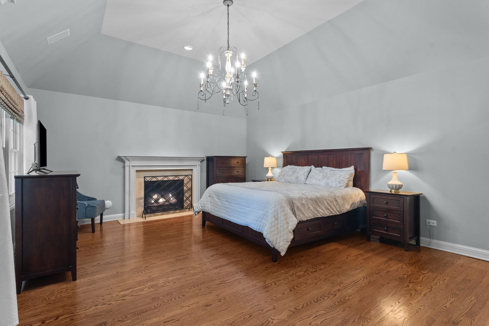 720 Newcastle Drive Lake Forest, IL 60045 - Photo 28 of 42 a spacious bedroom with a bed and a fireplace