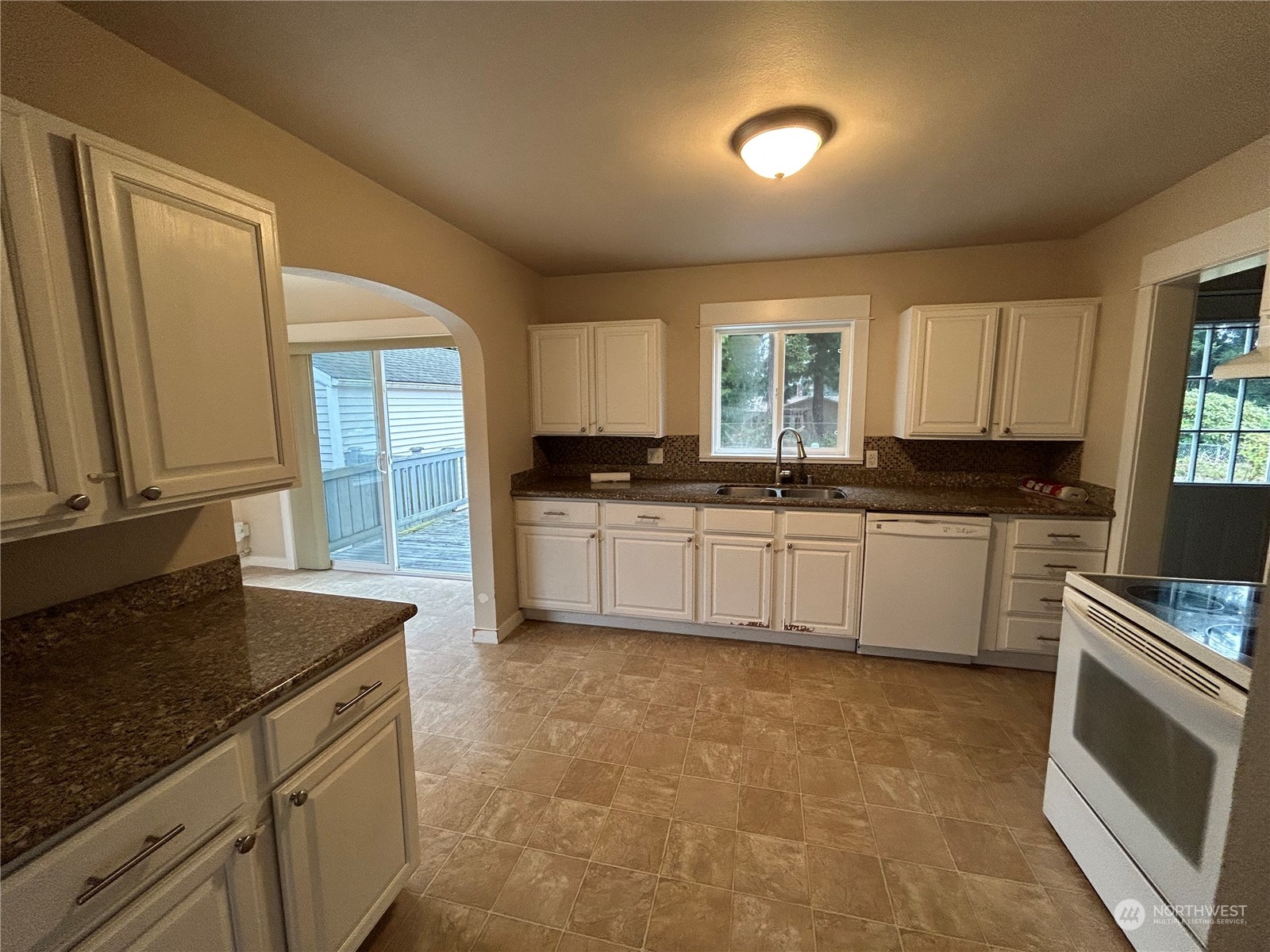 6919 Cady Road Everett, WA 98203 - Photo 6 of 29 a kitchen with granite countertop a sink a stove cabinets and a refrigerator