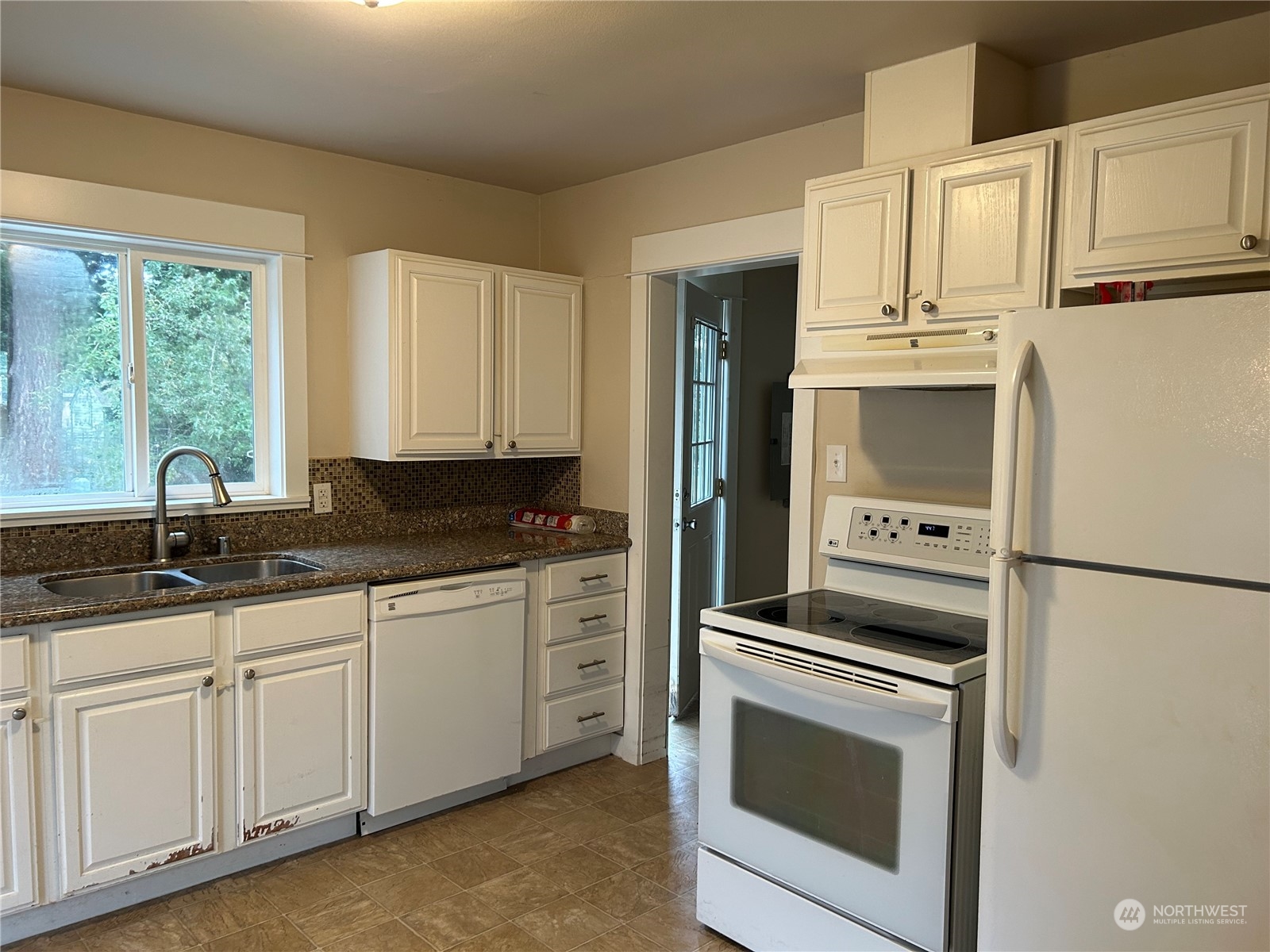 6919 Cady Road Everett, WA 98203 - Photo 9 of 29 a kitchen with granite countertop white cabinets white stainless steel appliances and sink
