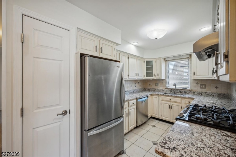 175 Chestnut Street, Unit B Boonton, NJ 07005 - Photo 13 of 30 a kitchen with a refrigerator a sink and cabinets