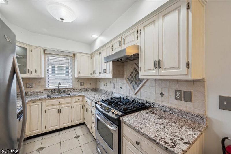 175 Chestnut Street, Unit B Boonton, NJ 07005 - Photo 14 of 30 a kitchen with stainless steel appliances granite countertop a stove sink and cabinets