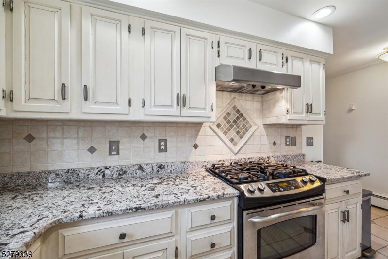 175 Chestnut Street, Unit B Boonton, NJ 07005 - Photo 16 of 30 a kitchen with granite countertop a stove and a white cabinets