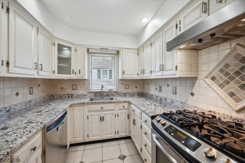175 Chestnut Street, Unit B Boonton, NJ 07005 - Photo 17 of 30 a kitchen with stainless steel appliances granite countertop a stove sink and cabinets