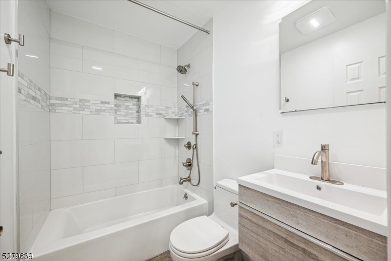 175 Chestnut Street, Unit B Boonton, NJ 07005 - Photo 18 of 30 a bathroom with a bathtub shower sink vanity and toilet