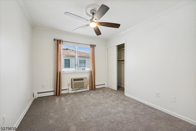175 Chestnut Street, Unit B Boonton, NJ 07005 - Photo 26 of 30 an empty room with chandelier fan and windows