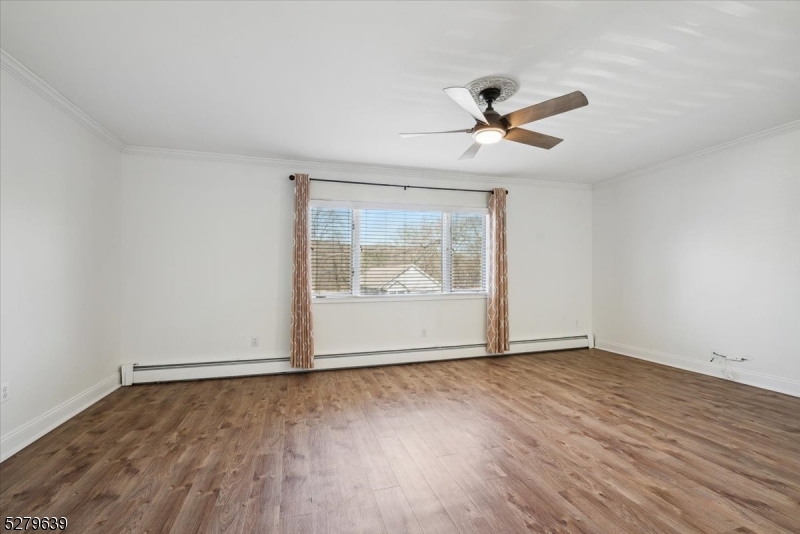 175 Chestnut Street, Unit B Boonton, NJ 07005 - Photo 3 of 30 an empty room with wooden floor and windows