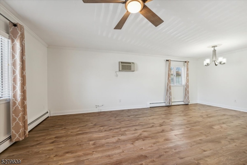 175 Chestnut Street, Unit B Boonton, NJ 07005 - Photo 5 of 30 an empty room with wooden floor ceiling fan and windows