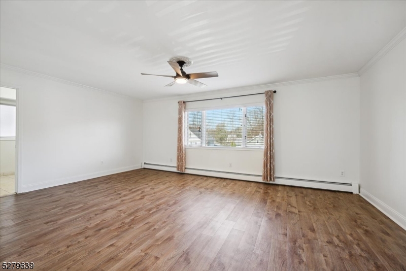 175 Chestnut Street, Unit B Boonton, NJ 07005 - Photo 6 of 30 a view of an empty room with wooden floor and a window