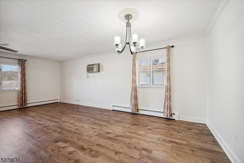 175 Chestnut Street, Unit B Boonton, NJ 07005 - Photo 8 of 30 an empty room with wooden floor mirror and windows