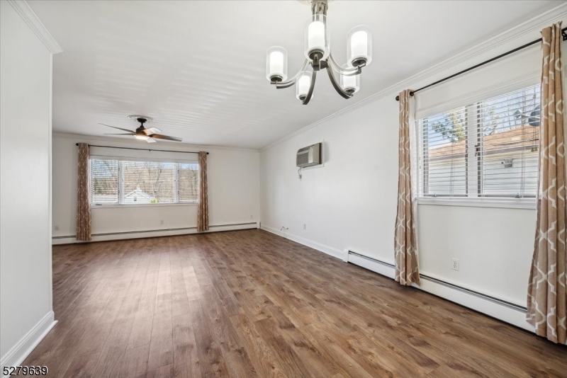 175 Chestnut Street, Unit B Boonton, NJ 07005 - Photo 9 of 30 an empty room with wooden floor cabinet and windows