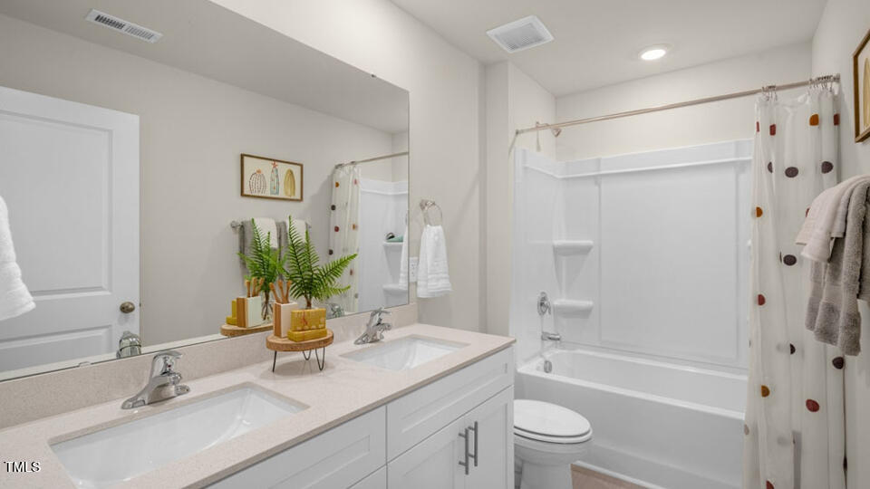 1256 Pavo Path Wendell, NC 27591 - Photo 12 of 30 a bathroom with a granite countertop sink a toilet and shower