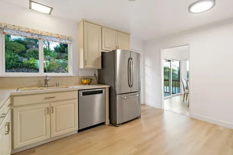 a kitchen with white cabinets and white stainless steel appliances