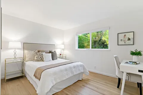 a bedroom with a bed and a desk