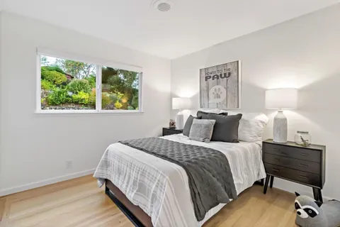 a bedroom with a bed and a window