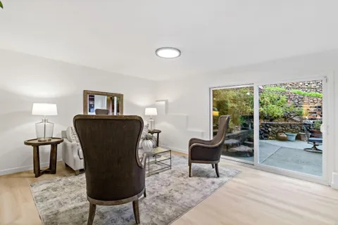a view of a livingroom with furniture and a potted plant