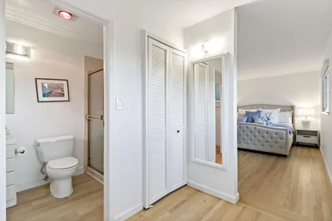 a bathroom with a toilet sink and a mirror