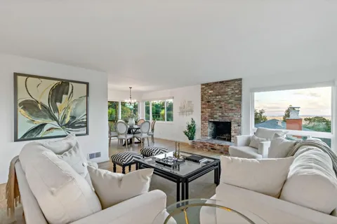a living room with furniture ceiling fan and a fireplace