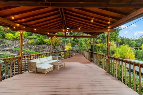 a view of chairs and table in the balcony