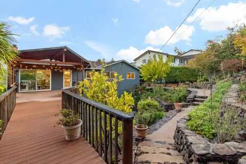 a view of a house with wooden deck