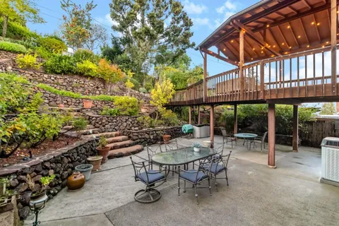 a view of a patio with table and chairs and potted plants